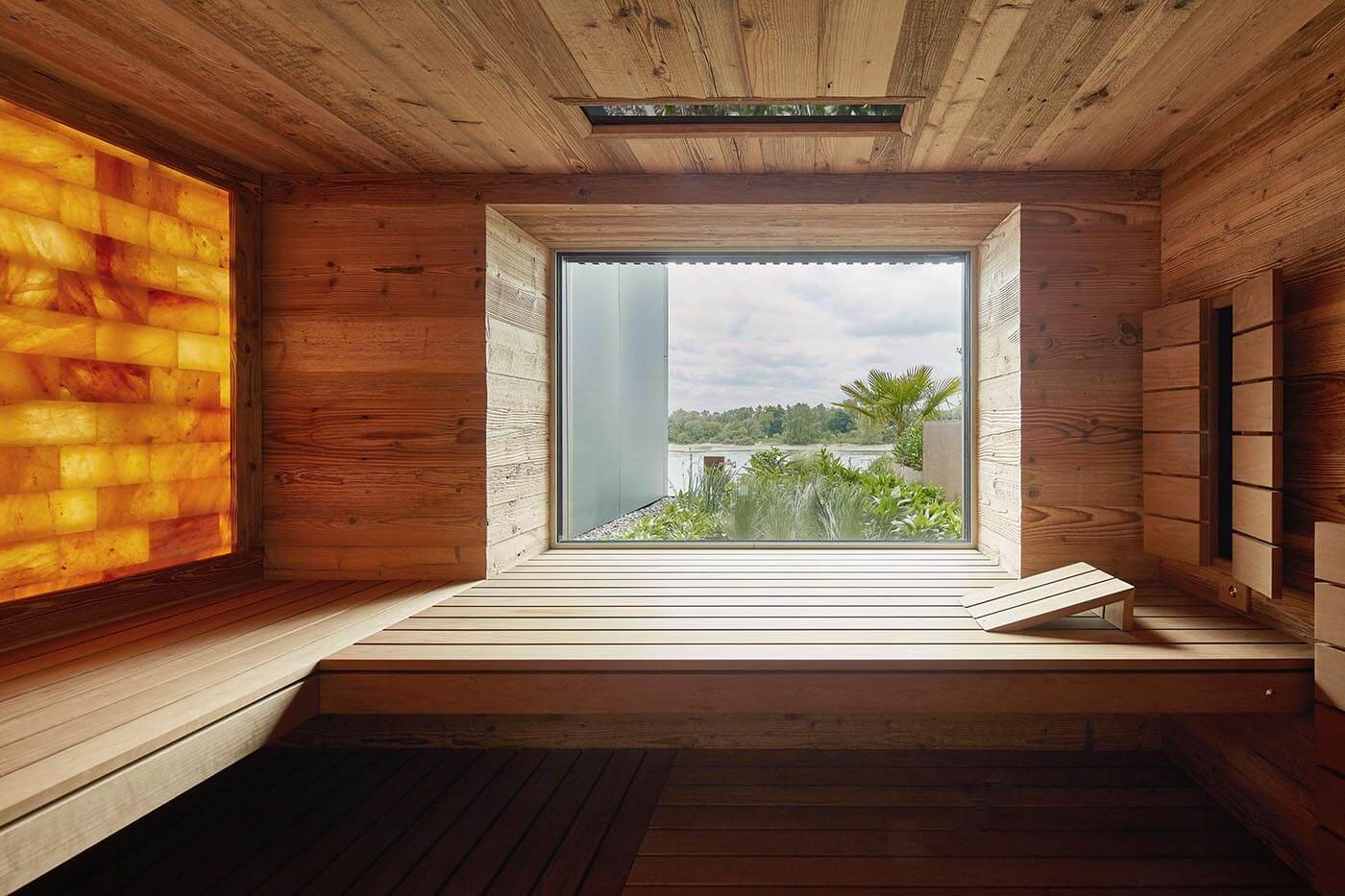 Reclaimed wood sauna with salt stone wall 16 Reclaimed wood sauna with light reclaimed wood and backlit salt stone wall as well as integrated window