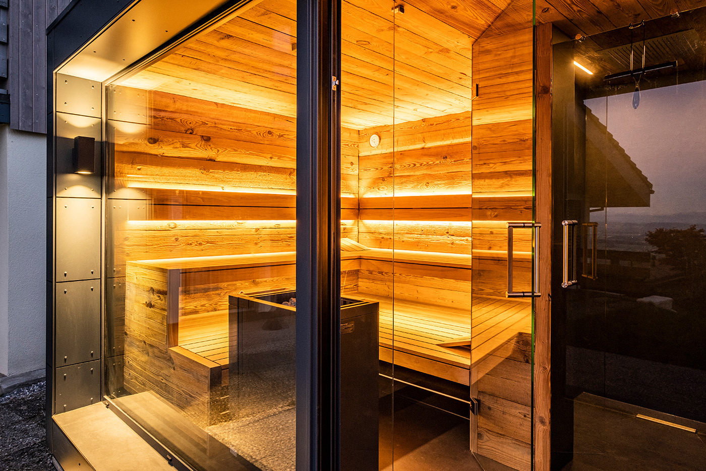 Moderne Außensauna mit Glasfront 67 Hochwertige Außensauna mit Ruheraum, Dusche und Sauna aus Altholz. Maßanfertigung der corso sauna manufaktur.